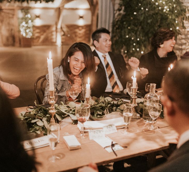 Wedding guests laughing during the intimate wedding reception