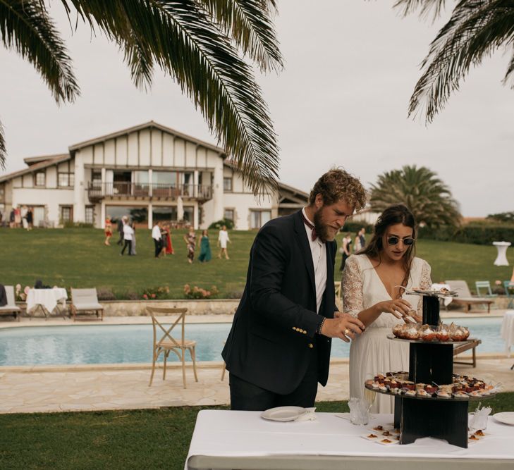 Bride in Donatelle Godart Wedding Dress at Poolside Drinks Reception