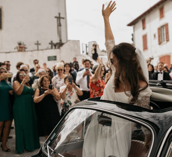 Bride in Donatelle Godart Wedding Dress Waving out of a Fiat 500 Sun Roof