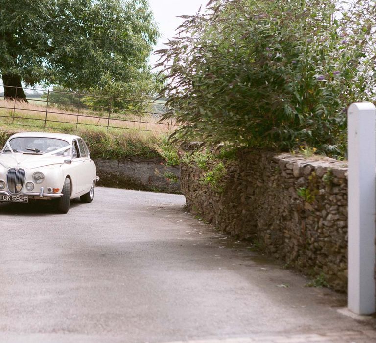 Vintage wedding car arriving at Shilstone House wedding ceremony