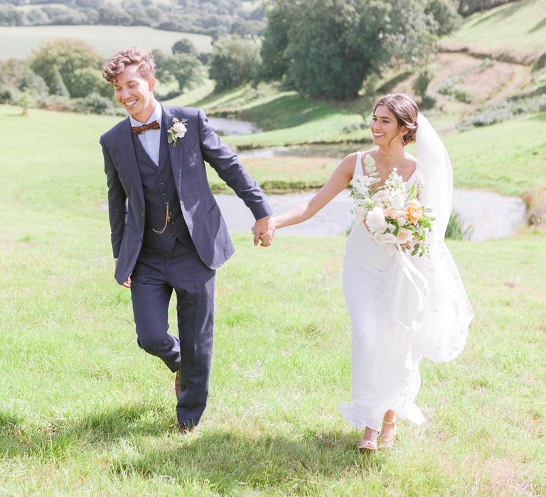 Groom in navy suit and bowtie at Shilstone House wedding