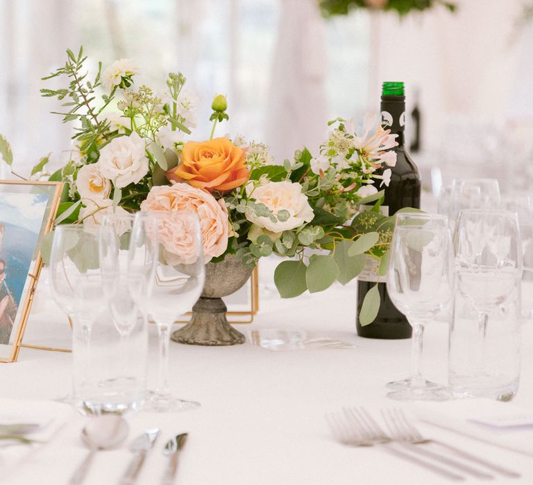 Table centrepieces with blush and peach roses