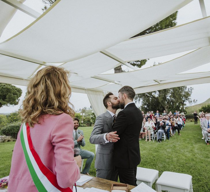 Groom and groom kiss