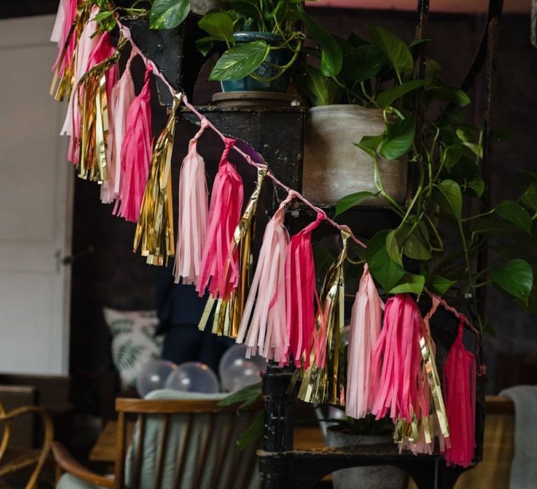 Pink and gold hanging tassel decor at casual and relaxed wedding ceremony in London