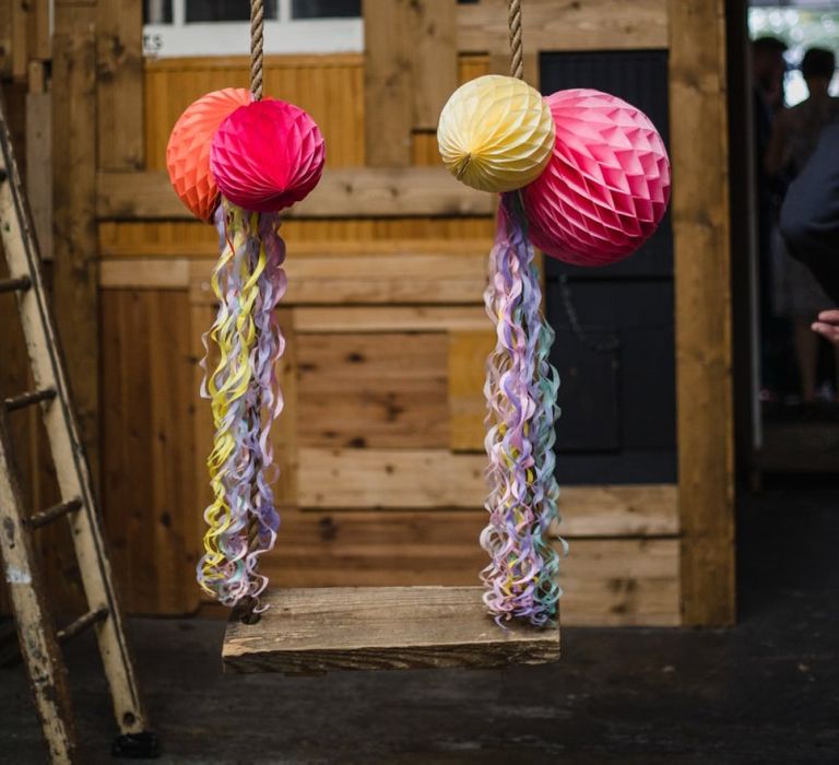 Brightly coloured paper lanterns at industrial wedding ceremony