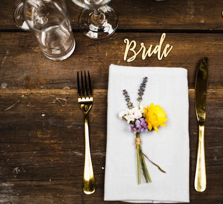 Brides industrial table setting with delicate floral decor tied with string