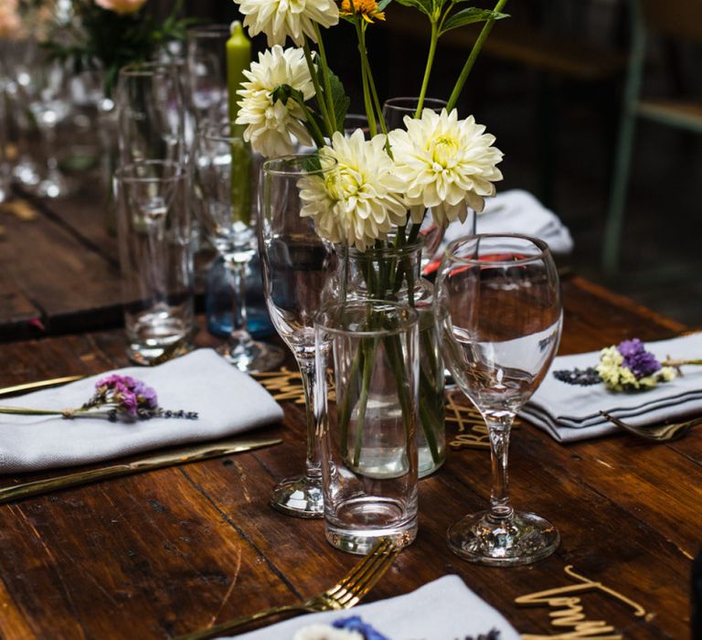 Industrial wedding reception in London with lots of bright floral decor