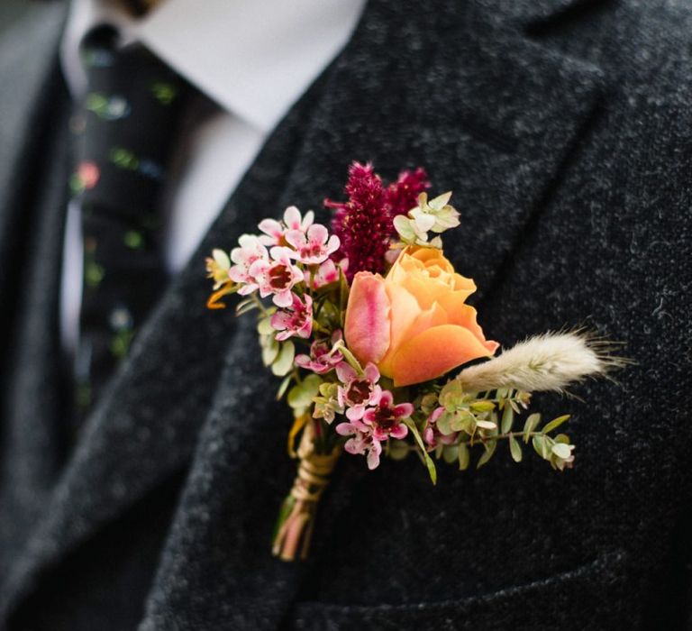 Pink and orange floral buttonhole arrangement at casual wedding in London