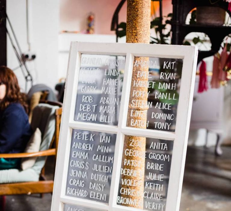 Glass window table plan with white details for industrial wedding in London