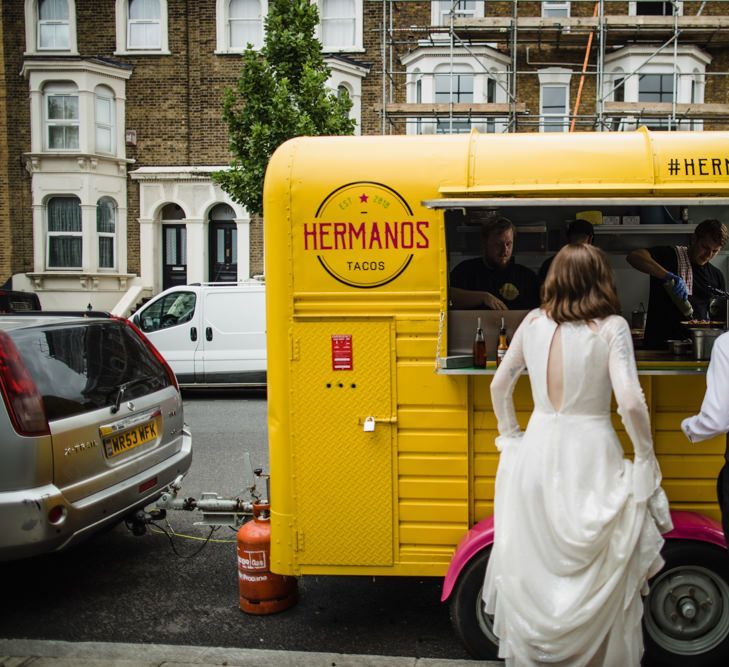 Bride in glasses and groom at London wedding with taco truck