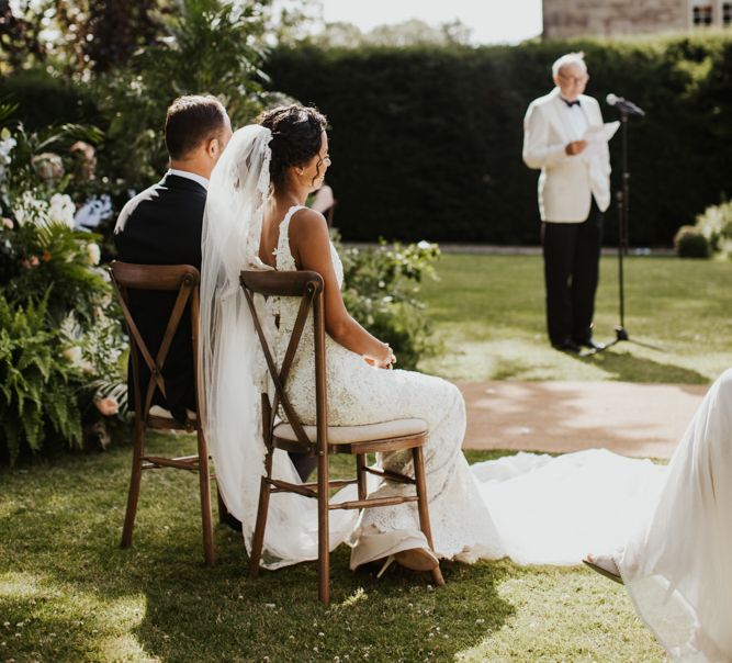 Bride and groom listening to the wedding readings during the ceremony