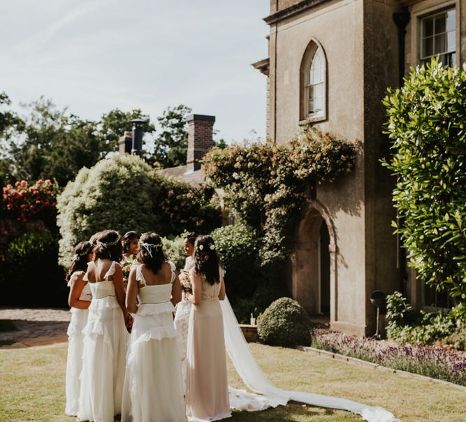 Bridesmaids in white dresses at Babington House wedding venue