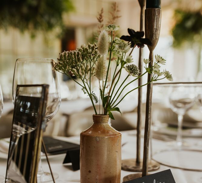 Ink wells filled with flower stems at Babington House wedding reception