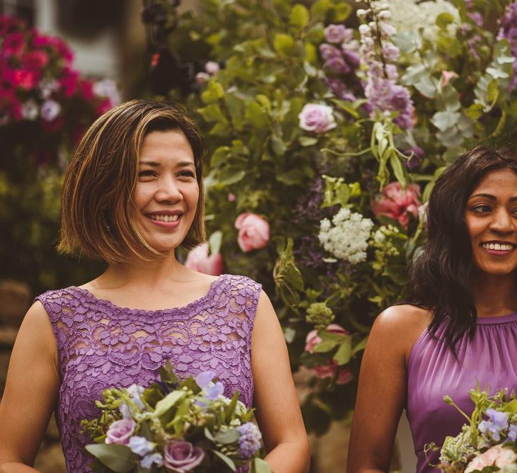 Bridesmaids in different purple dresses