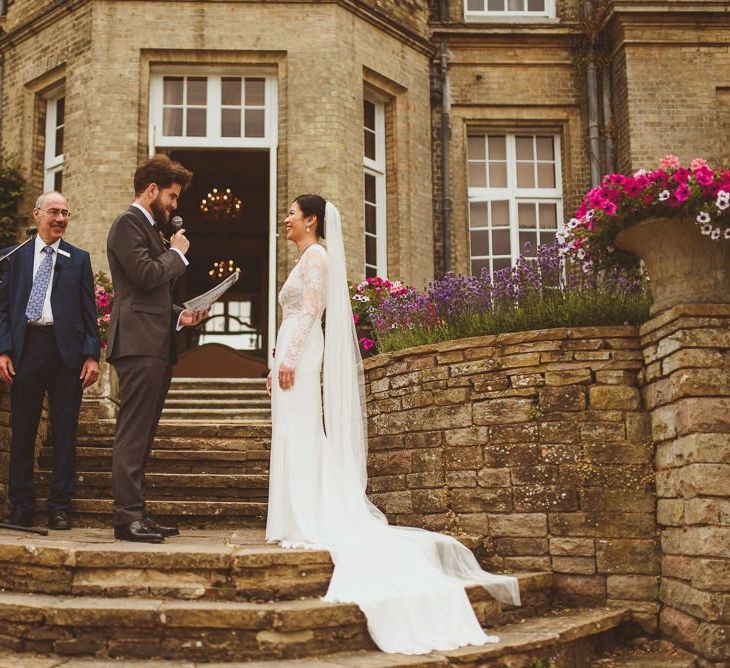 Bride and groom exchanging vows at Hedsor House wedding ceremony