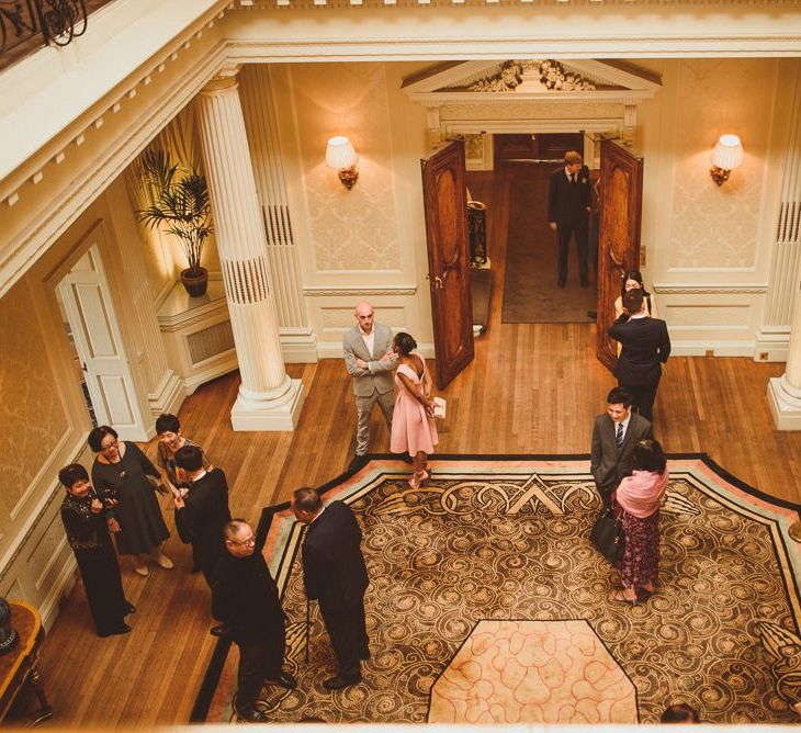 Wedding guests congregating at the lobby at Hedsor House