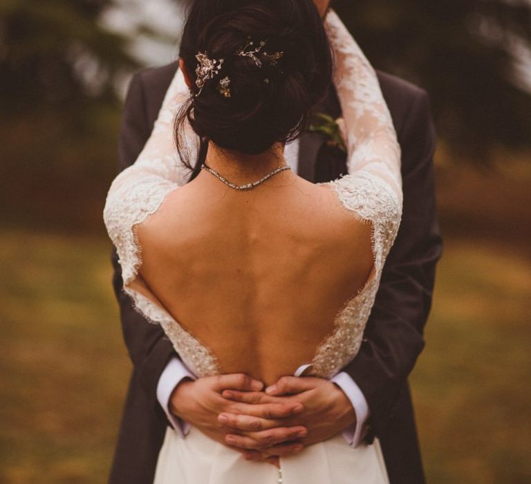 Intimate bride and groom portrait with bride in low back wedding dress