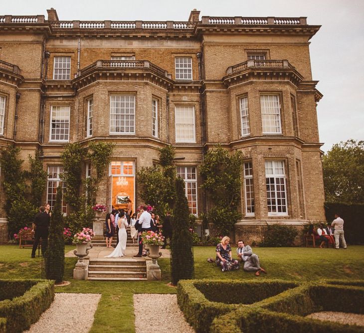 Wedding guests outside at c country house