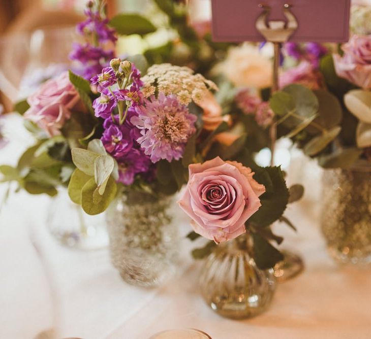 Purple and white flower stems in bottles