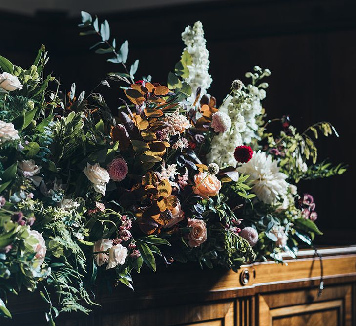 White, apricot and dusky pink flowers at autumn styled wedding reception in East London