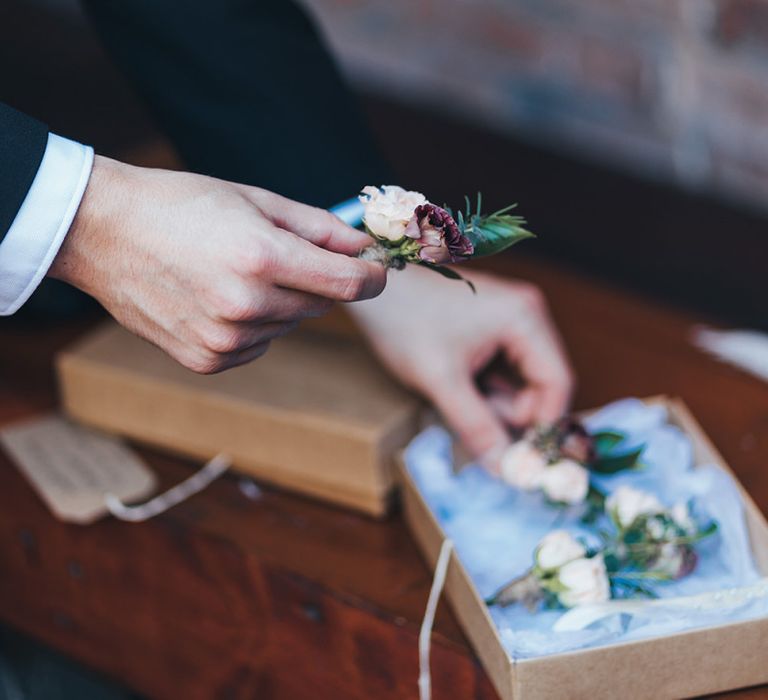 Buttonhole autumnal wedding flowers with burgundy and dusky pink detail