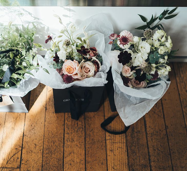 Autumn wedding bouquets using apricot, white and burgundy flowers for city wedding