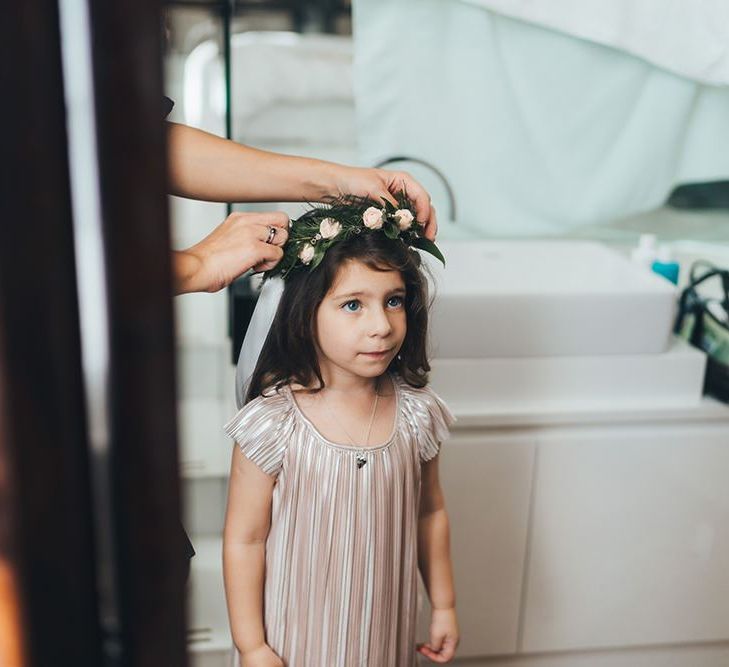 Flower girl with dusky pink floral head crown and nude dress with black bridesmaid dresses at city wedding