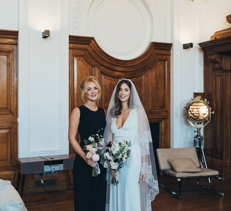 Bride and bridesmaids in elegant black bridesmaid dresses