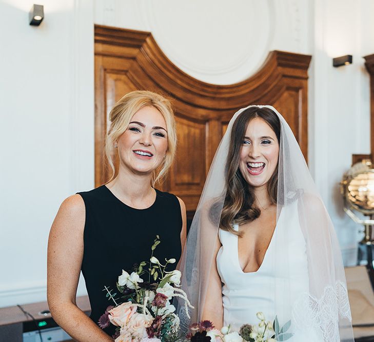 Bride and bridesmaids in elegant black bridesmaid dresses