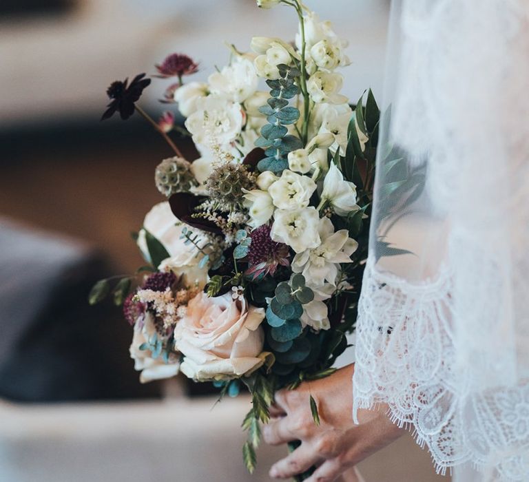 Autumn themes wedding bouquet with white, apricot and burgundy flowers