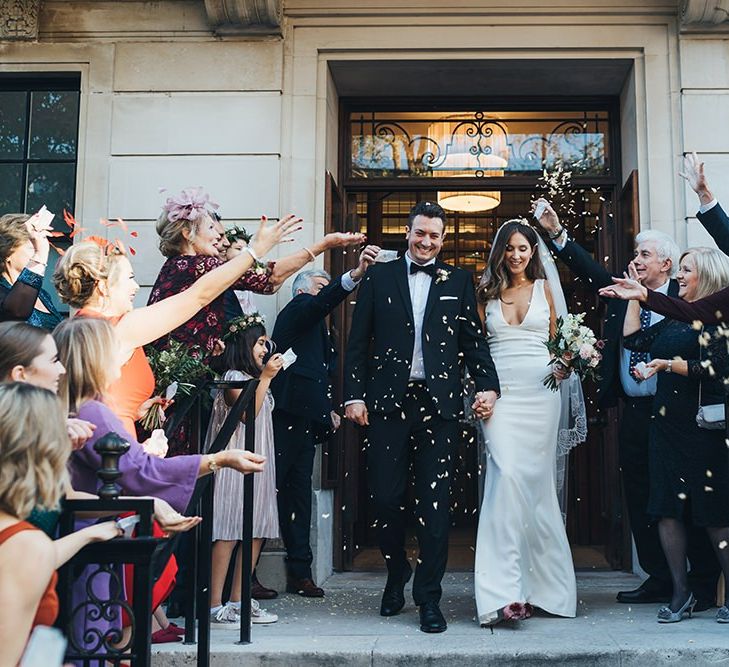 Bride and Groom confetti shot with black bridesmaid dresses