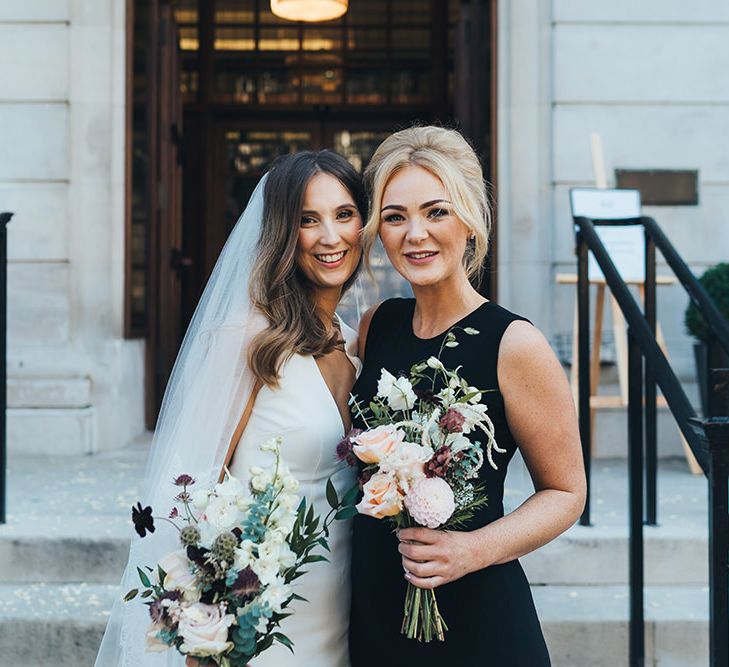 Bride and bridesmaids in elegant black bridesmaid dresses