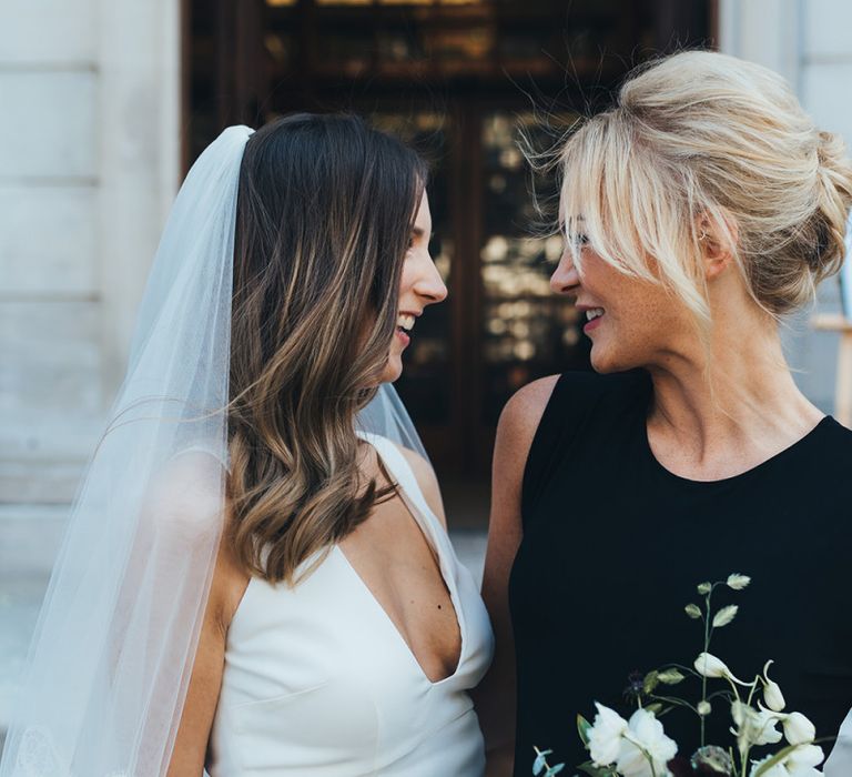 Bride and bridesmaids in elegant black bridesmaid dresses