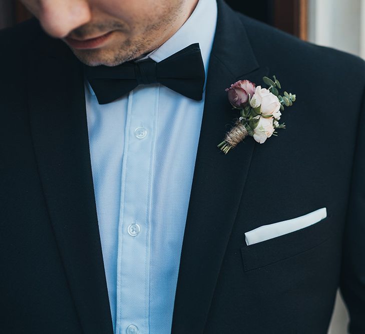 Black tie wedding with apricot and burgundy buttonhole flowers