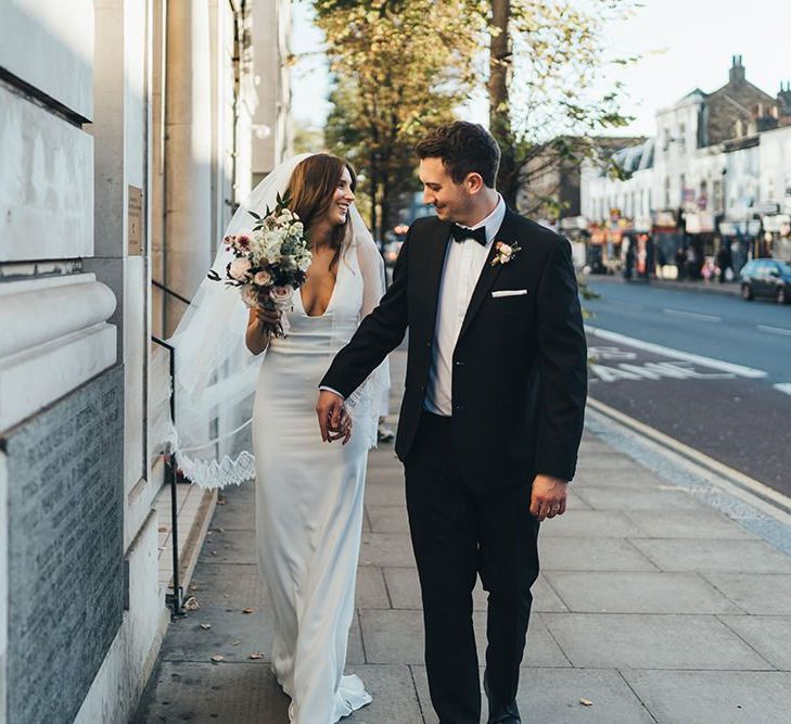 Bride and Groom take a moment to enjoy their relaxed autumn city wedding