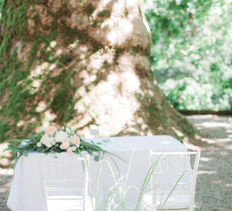 Altar Chairs with Green and Peach Floral Arrangements