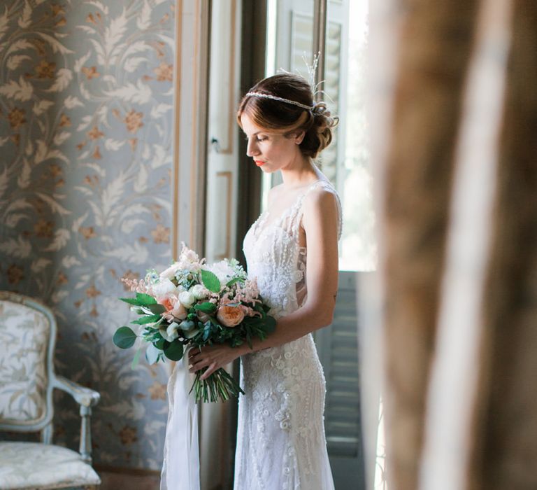 Bride Holding a Peach, Pink and White Bouquet  in Lace Atelier Eme Wedding Dress and Headdress