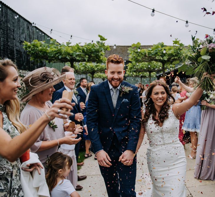 Confetti Exit with Bride in Lace Roland Joyce Bridal Wedding Dress and Groom in Navy Suit