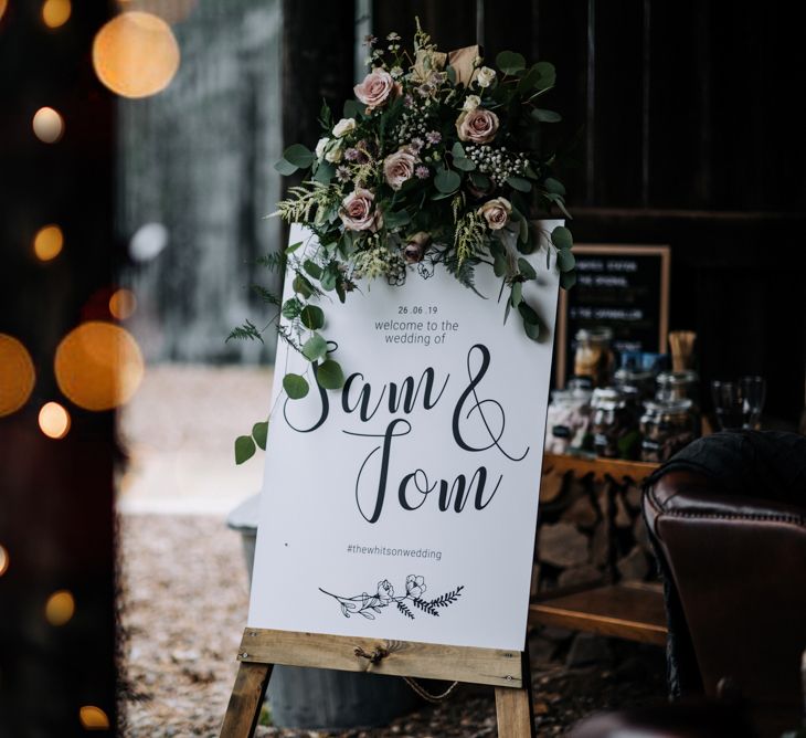 Calligraphy Wedding Welcome Sign with Floral Decor on a Wooden Easel