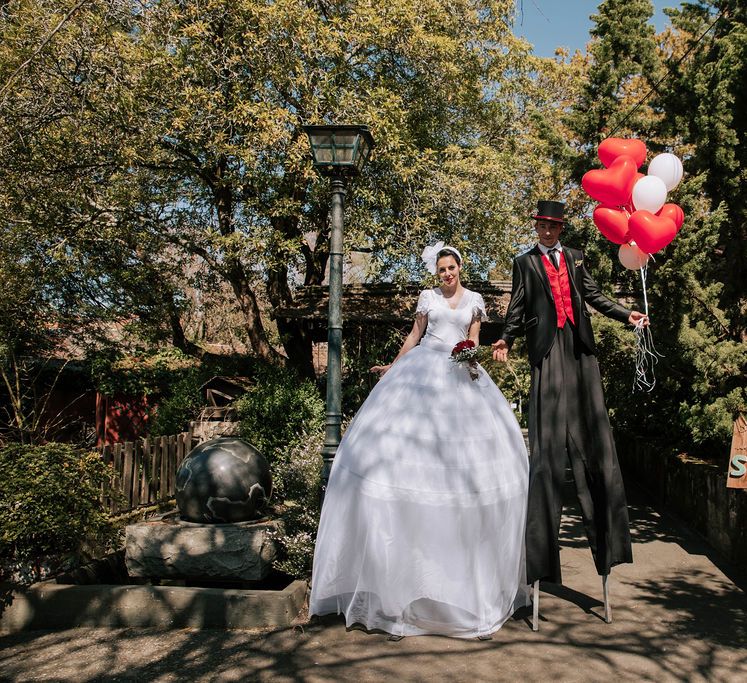 Wedding Entertainers on Stilts Handing Out Balloons