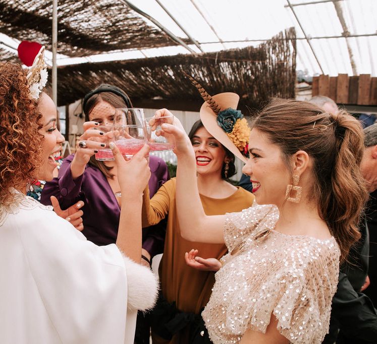 Bride with Afro Hair in Gold Headdress, Patricia Meléndez Wedding Dress and coat Enjoying a Drink with her friends