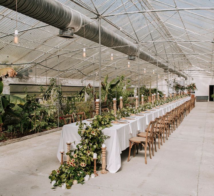 Fundación Sales Glasshouse Wedding Venue with Botanical Plants, Greenery Table Runner and Wooden Candlesticks