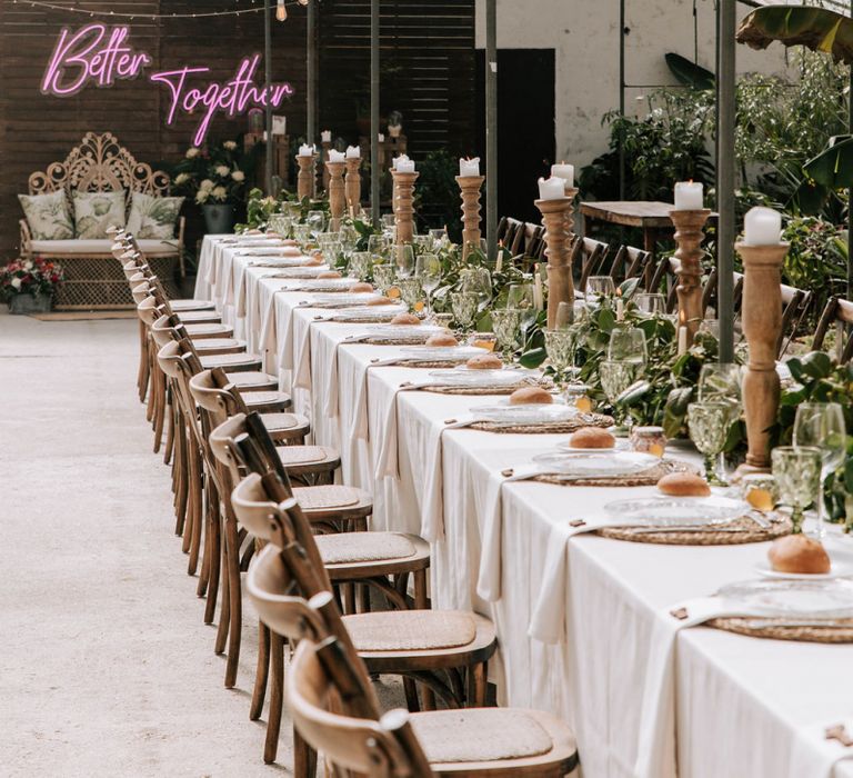 Tablescape with Galician camellias centrepiece and wooden candlesticks