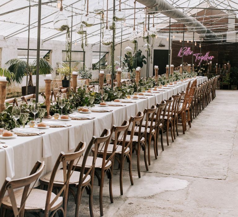 Glasshouse Wedding Venue with Tablescape with Galician camellias centrepiece and wooden candlesticks