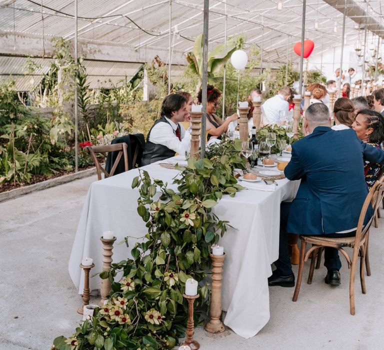 Wedding Reception Decor with Trailing Galician camellias centrepiece and wooden candlesticks