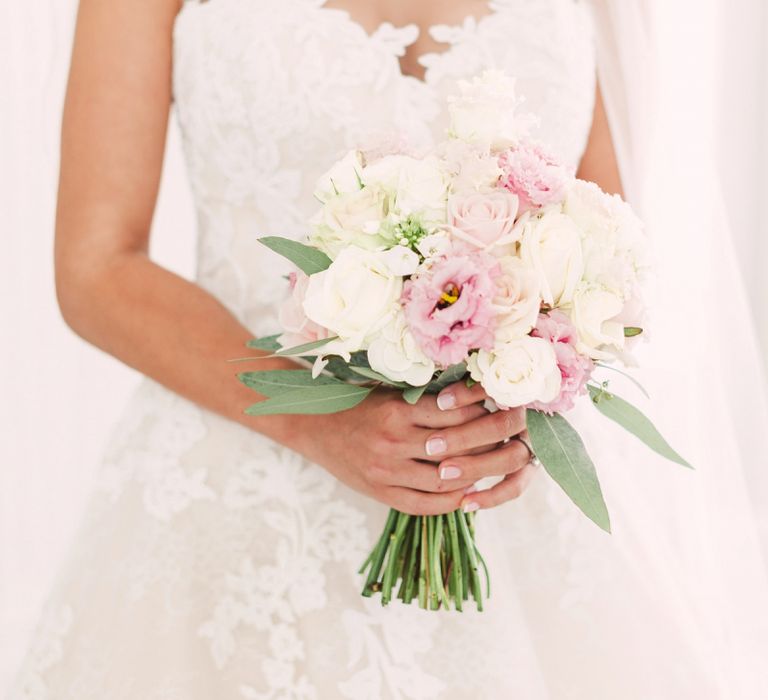 Bride in Lace Illusion Neck Wedding Dress Holding Her Pink and White Rose Bouquet