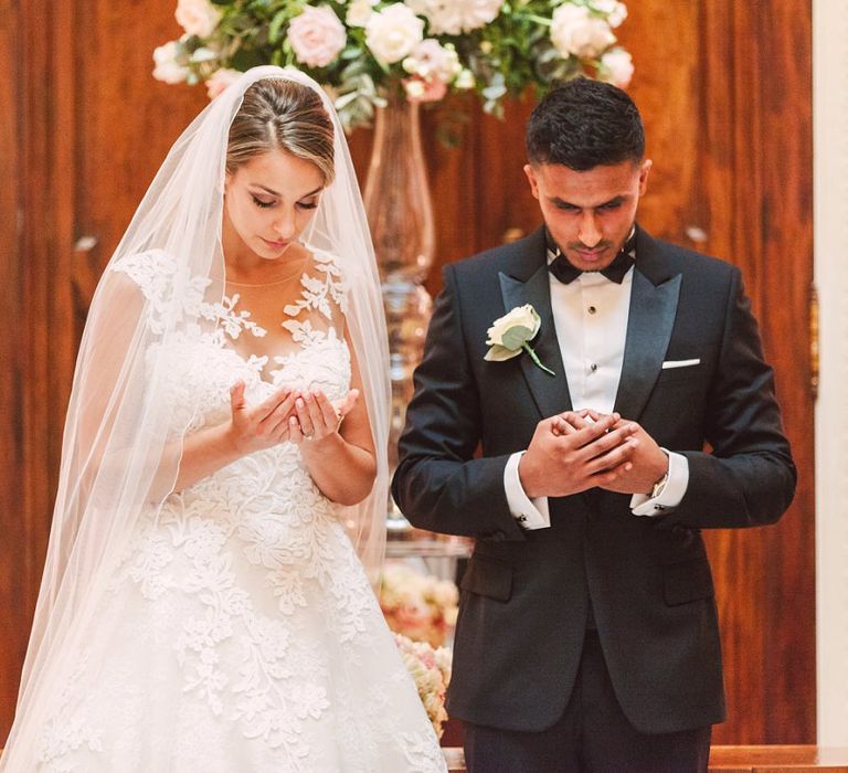 Bride in Lace Princess Wedding Dress and Groom in Tuxedo During Their Wedding Ceremony