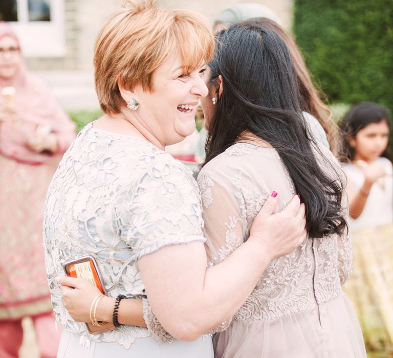 Mother of The Bride and Wedding Guest Embracing