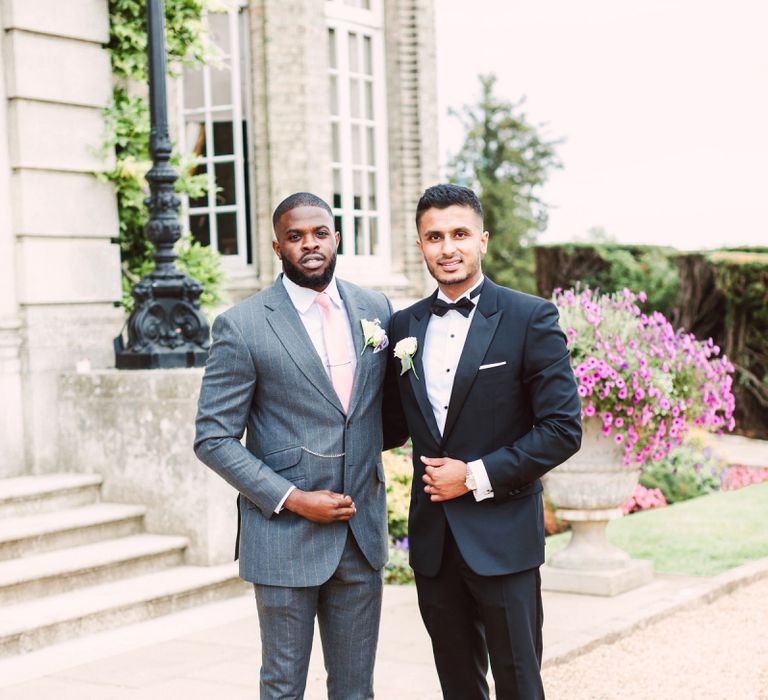 Groom in Black Tie Suit and Groomsman in Grey Suit