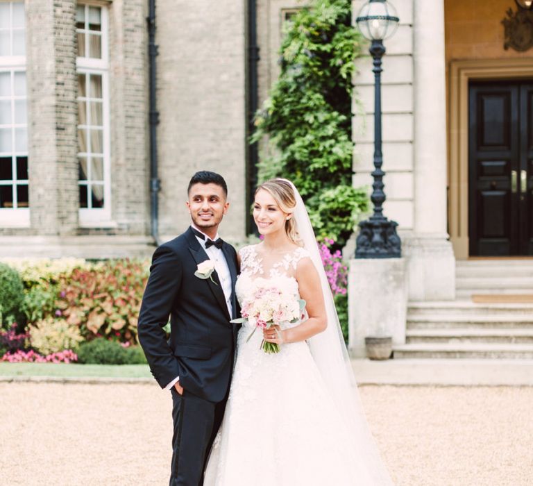 Bride in Lace Pronovias Wedding Dress and Groom in Black Tie Suit